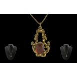 Ladies 9ct gold single stone garnet set ornate pendant with attached 9ct gold chain. both chain