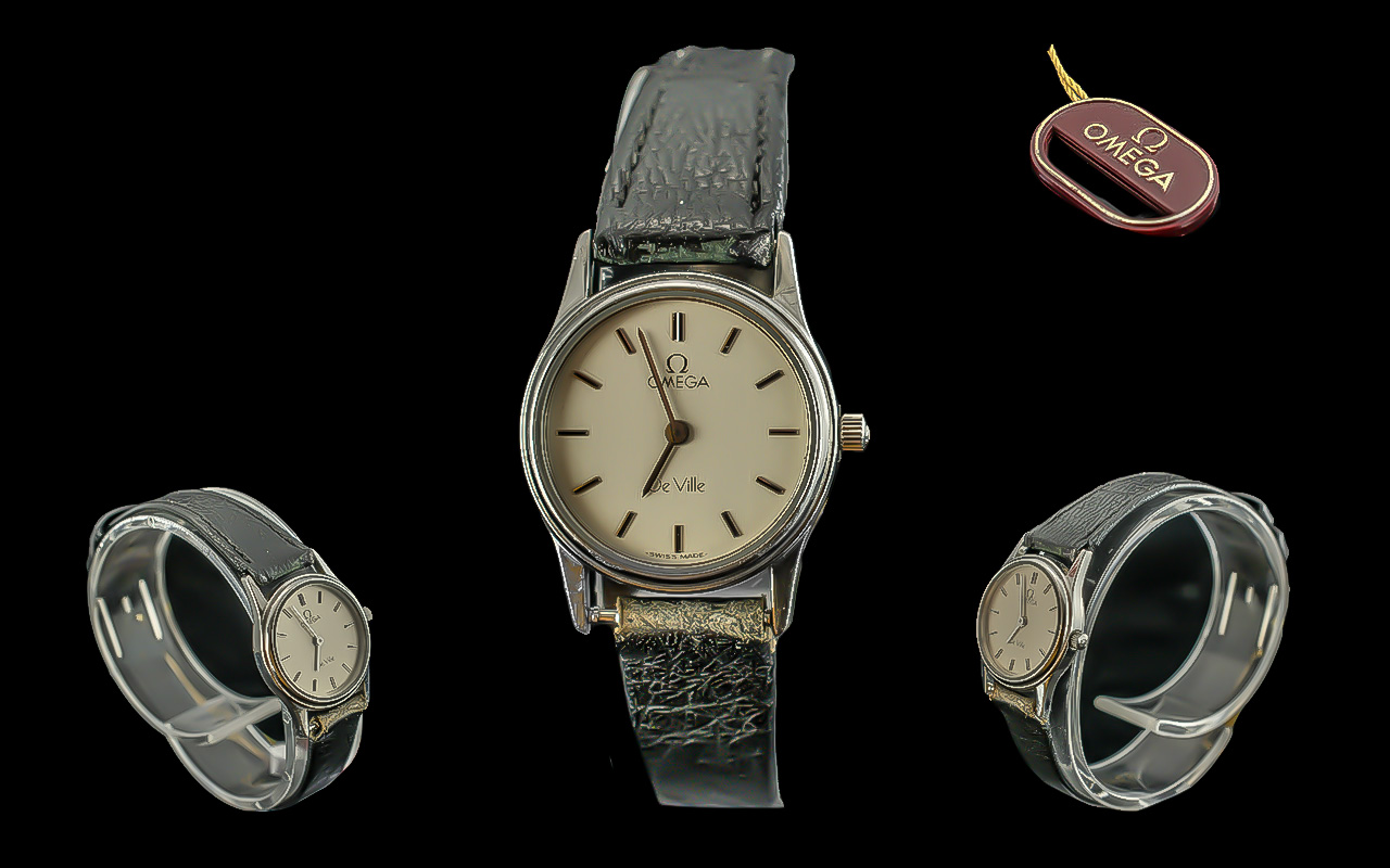 Ladies Omega Wristwatch, black leather strap, white face with gold baton markers, as new label