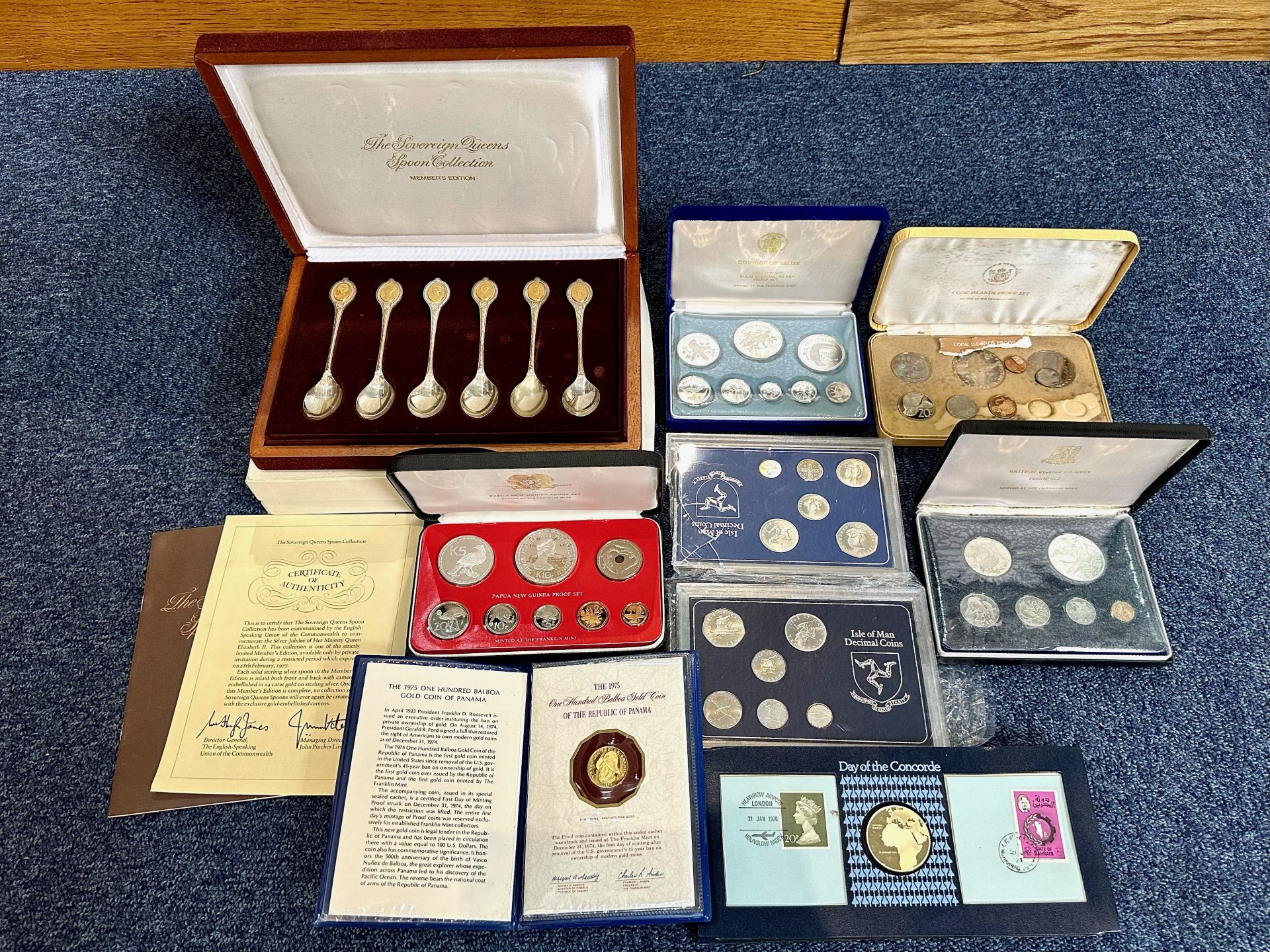 A Collection of Coins to Contain a boxed set of silver spoons, commemorative coins, proof sets,