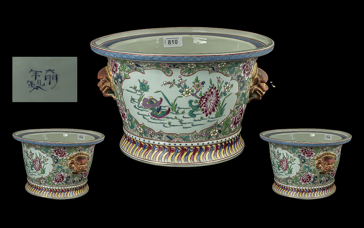 Large Japanese Jardiniere, with foo dog mask handles, panels of blossom. Marks to base. Diameter
