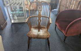 Windsor Chair Armchair, spindle back of typical form, with low seat. Height 14