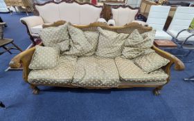 Bergere Settee, carved arm rests and back, raised on lion claw and ball feet. Drop in cushions. 75''