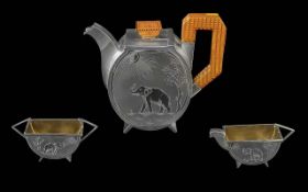 An Art Deco Three Piece Silver Tea Service, Indian Silver, Each Piece Decorated with Chased Image of