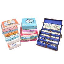 Sixteen vintage party games and a Mahjong set in leather case.
