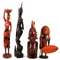 A collection of African and Asian carved wooden figures, animals and masks.