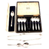 A cased set of silver teaspoons, sugar tongs and other loose spoons.