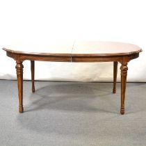 Modern walnut extending dining table and eight cane-backed chairs,