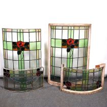 Two large bowed leaded and stained glass windows, in the Arts and Crafts style