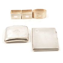 Two silver cigarette cases and three napkin rings.