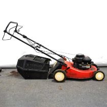 A Briggs & Stratton Champion 375 lawnmower and an AL-KO H 1600s shredder with instruction book.