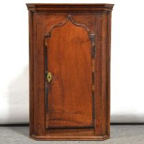 George III oak and mahogany hanging corner cupboard,