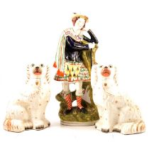 Staffordshire pottery Scotsman and a pair of dogs,