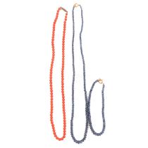 A sapphire tumblestone necklace, matching bracelet and coral necklace with diamond clasp.