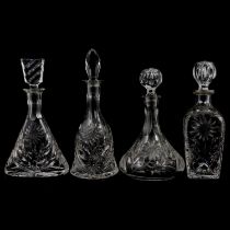 Four glass decanters with sunflower design.