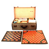 A vintage suitcase containing vintage games and playing cards, boards etc.