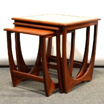 A nest of three teak G Plan tables with tile tops.