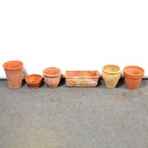 Six terracotta garden pots.