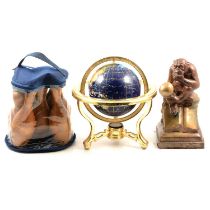 Small table globe, carpet skittles, and a sculpture of a Darwin Monkey thinking