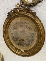 Early 19th century needlework panel in a gilt frame, mirror, and a brass and onyx candelabra