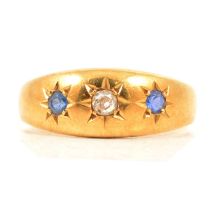 A sapphire and diamond gypsy set ring.