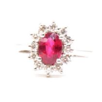 A ruby and diamond cluster ring.