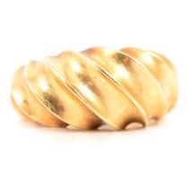 A yellow metal fluted ring marked 18K.