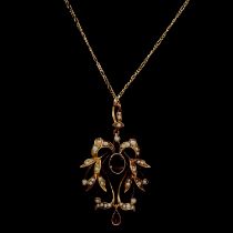 An Edwardian garnet and pearl pendant and chain.