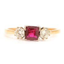 A ruby and diamond three stone ring.