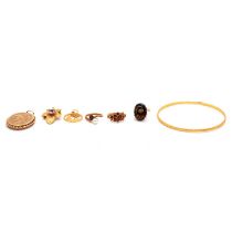 A 9 carat gold locket, gemset rings, leaf brooch, pendant, and gold-plated upper arm bangle.