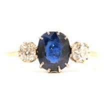 A sapphire and diamond three stone ring.