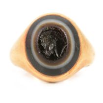A signet ring with intaglio carved banded agate.
