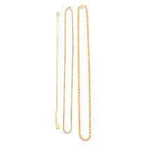 Three gold / yellow metal chains and a cultured pearl drop.