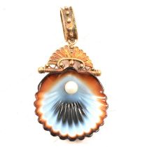 A carved banded agate and cultured pearl shell pendant.