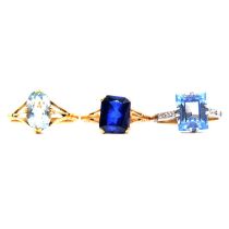 Three dress rings, aquamarine, synthetic blue spinel, and synthetic sapphire.
