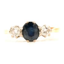 A sapphire and diamond three stone ring.