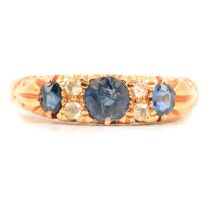 A sapphire and diamond half hoop ring.