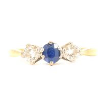 A sapphire and diamond three stone ring.