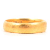 A 22 carat yellow gold wedding band.