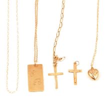 A small collection of 9 carat yellow gold and yellow metal pendants, crosses and chains.