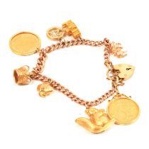 A gold charm bracelet with charms and two Gold Full Sovereign Coins.