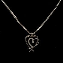 A diamond necklace and double heart shape pendant.