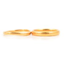 Two 22 carat gold wedding bands.
