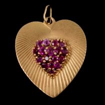 A 14K heart pendant set with untested pink stones.