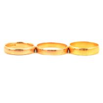 Three 22 carat yellow gold wedding bands.