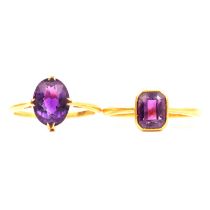 Two amethyst solitaire dress rings.