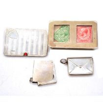 Four silver stamp cases,