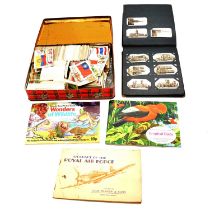A large collection of cigarette cards in albums, boxes and loose covering many subjects.