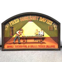 Two oval mahogany wall mirrors, and a reproduction advertising sign