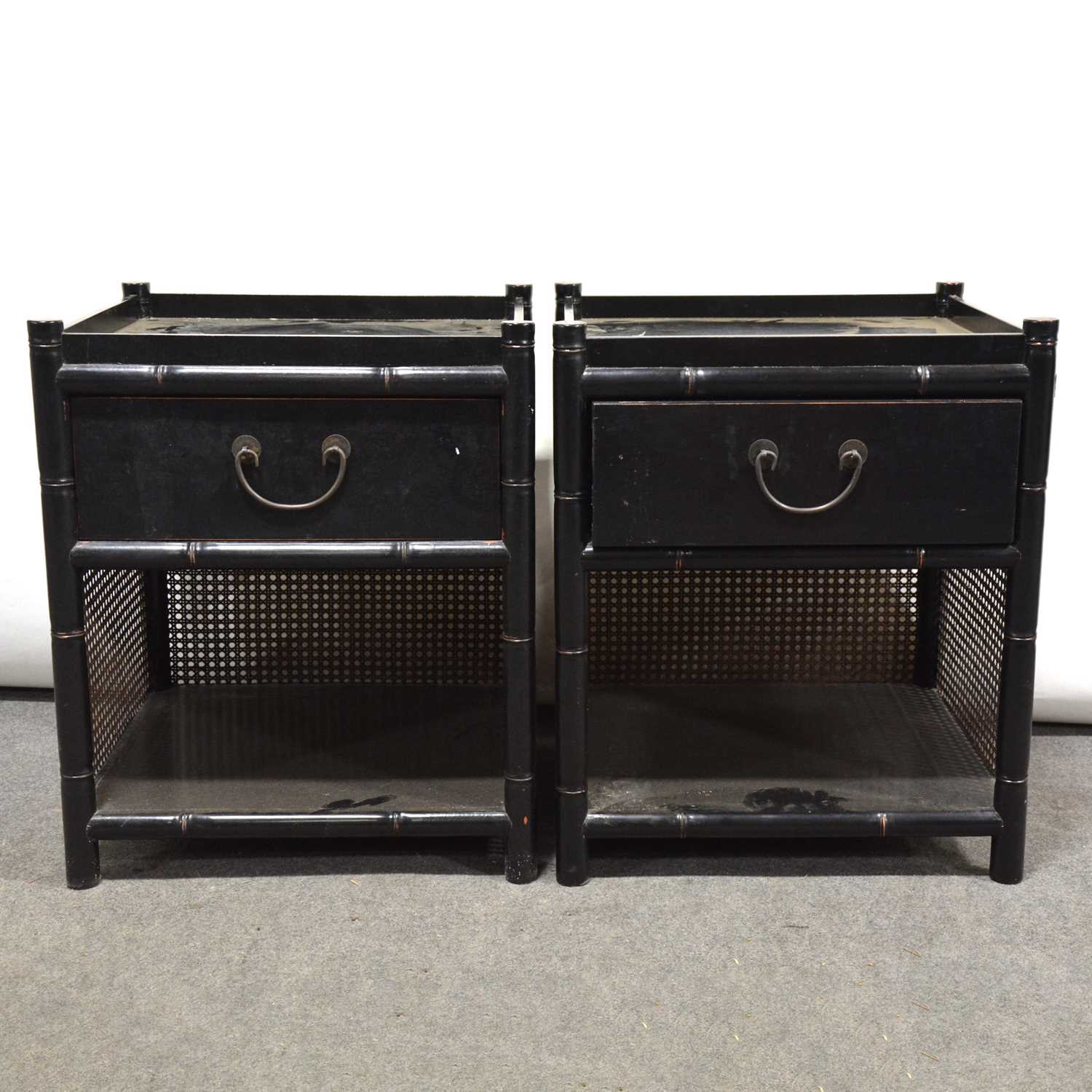 Pair of black painted and cane bedside cupboards.