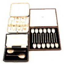 Three cased sets of silver spoons.